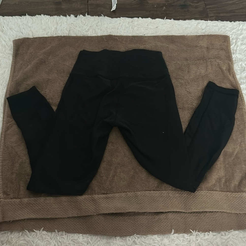 Black Lululemon leggings with mesh stripes on the back